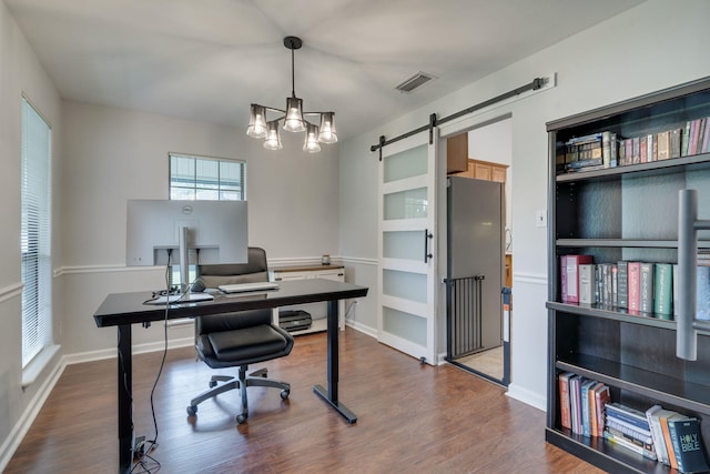 1989 Setting Sun Trl, Tallahassee, FL 32303 - home office featuring dark wood-style floors, a barn door, and a chandelier