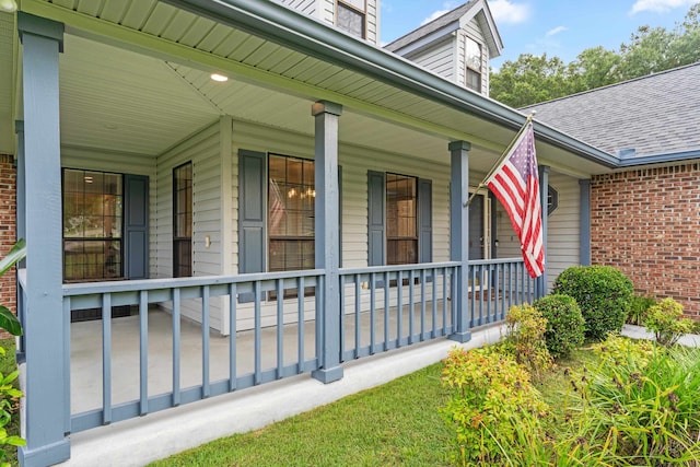 1989 Setting Sun Trl, Tallahassee, FL 32303 - entrance to property with covered porch, a shingled roof, and brick siding