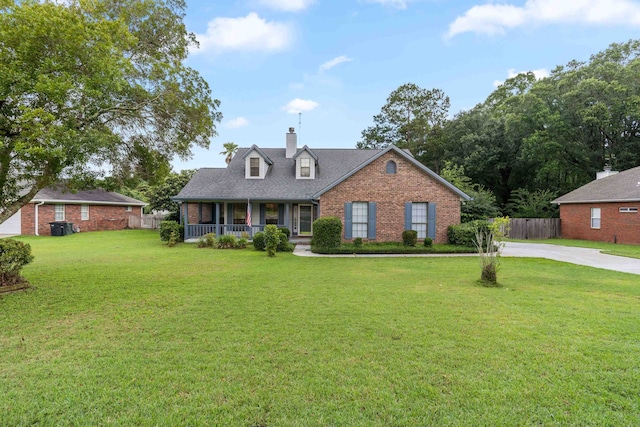 1989 Setting Sun Trl, Tallahassee, FL 32303 - cape cod house featuring a porch, brick siding, a chimney, and driveway