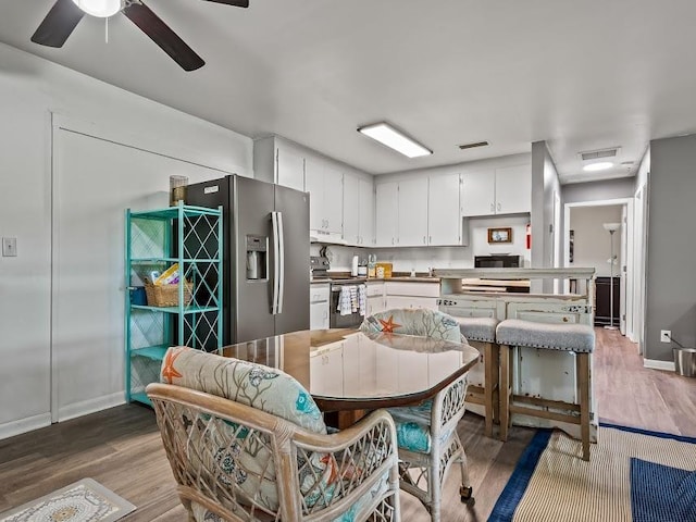 12 Lake Essay Dr, Panacea, FL 32346 - dining space featuring wood finished floors, ceiling fan, and baseboards