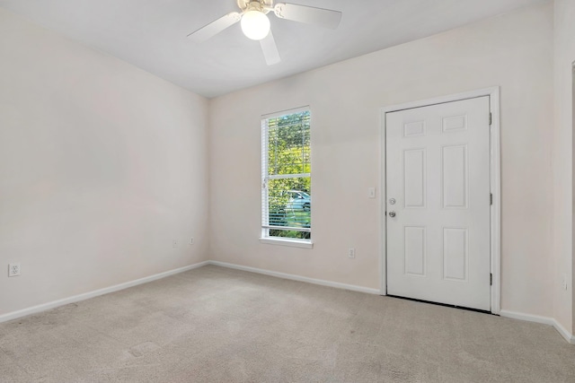 carpeted empty room featuring ceiling fan