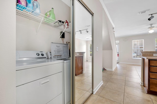 2400 Fred Smith Rd Unit 202, Tallahassee, FL 32303 - laundry room with separate washer and dryer, plenty of natural light, a ceiling fan, ornamental molding, and light tile patterned floors