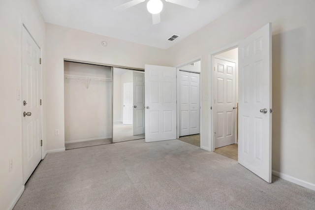 unfurnished bedroom with light colored carpet and ceiling fan