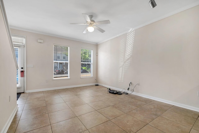 tiled empty room featuring ceiling fan and ornamental molding