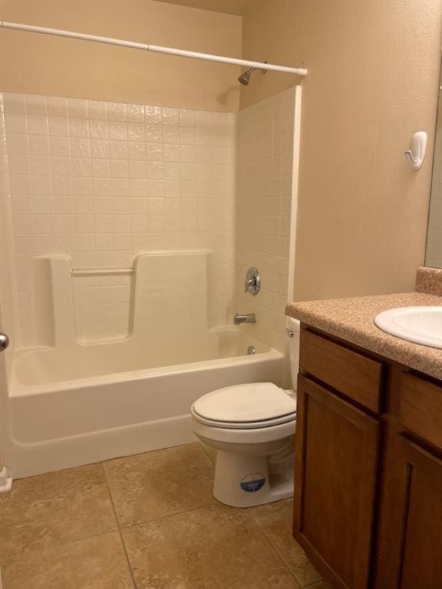 full bathroom featuring toilet, washtub / shower combination, vanity, and tile patterned floors