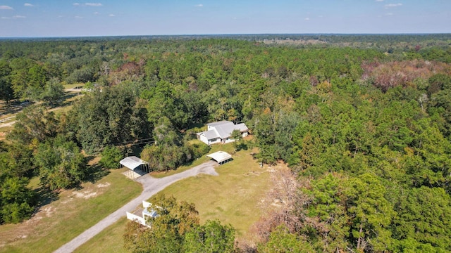 birds eye view of property with a view of trees
