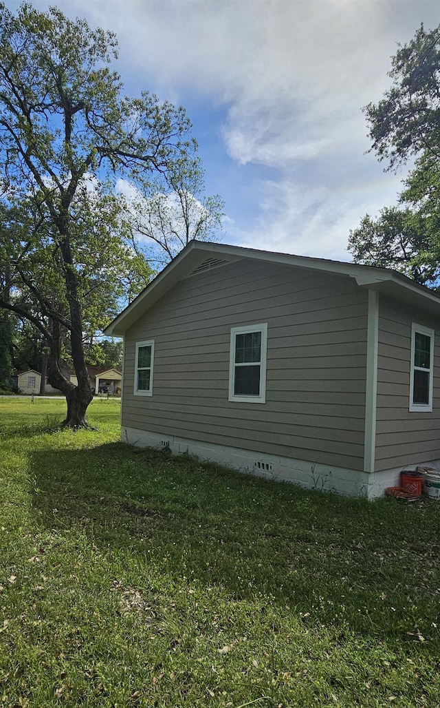 view of home's exterior with crawl space and a lawn