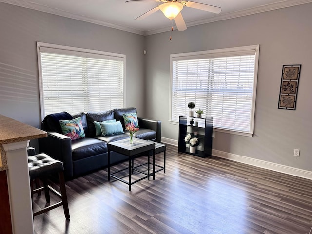 living area with ceiling fan, ornamental molding, dark wood-style flooring, and baseboards