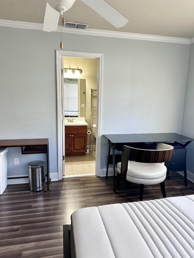 bedroom featuring dark wood-style floors, visible vents, connected bathroom, and ornamental molding