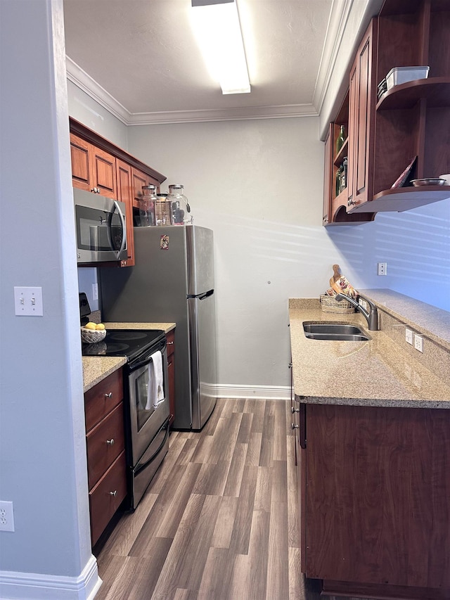 kitchen featuring appliances with stainless steel finishes, ornamental molding, light stone countertops, open shelves, and a sink