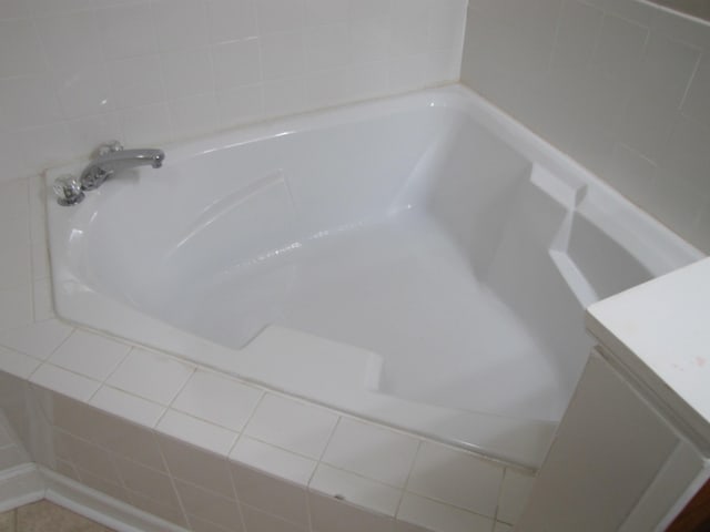 interior details with vanity and a tub
