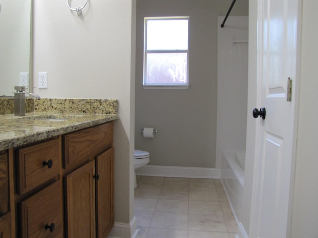 full bathroom featuring toilet, vanity, baseboards, tile patterned flooring, and bathing tub / shower combination