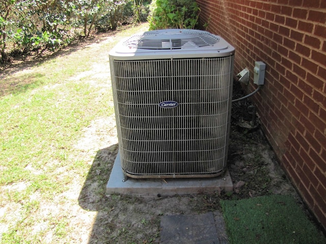exterior details featuring brick siding and central air condition unit