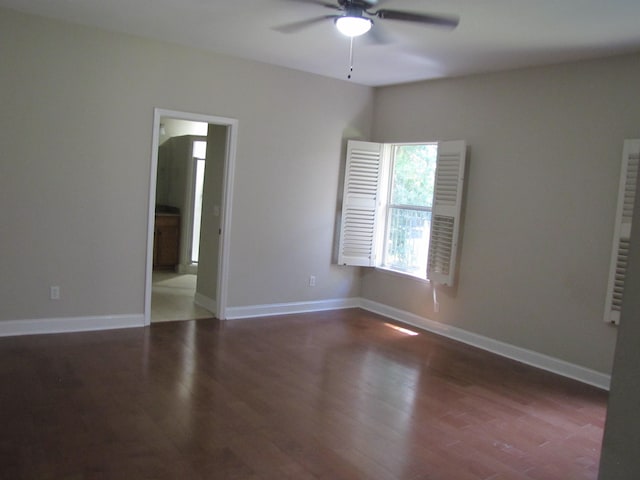 empty room with ceiling fan, baseboards, and wood finished floors
