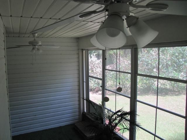 unfurnished sunroom with a ceiling fan
