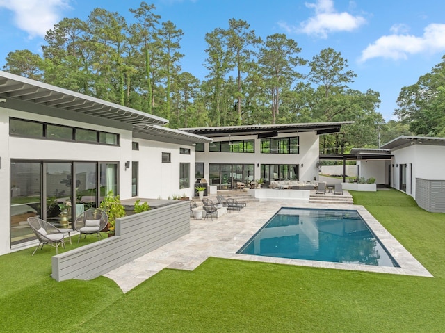 719 Middlebrooks Cir, Tallahassee, FL 32312 - rear view of property with an outdoor hangout area, a patio, a lawn, an outdoor pool, and stucco siding