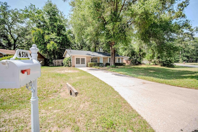 4514 Hickory Forest Cir, Tallahassee, FL 32303 - view of front of property with driveway, view of wooded area, and brick siding