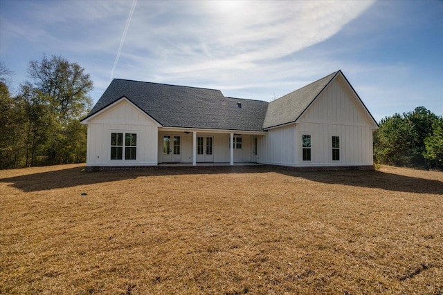 rear view of house featuring a lawn