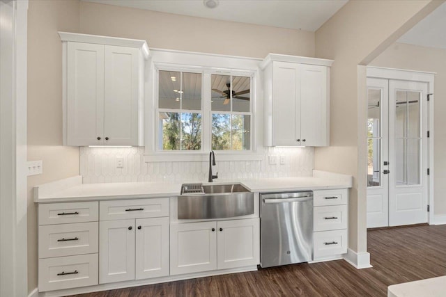 kitchen featuring dishwasher, sink, tasteful backsplash, dark hardwood / wood-style flooring, and white cabinets