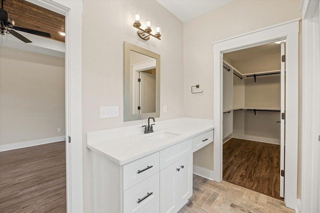 bathroom with ceiling fan and vanity