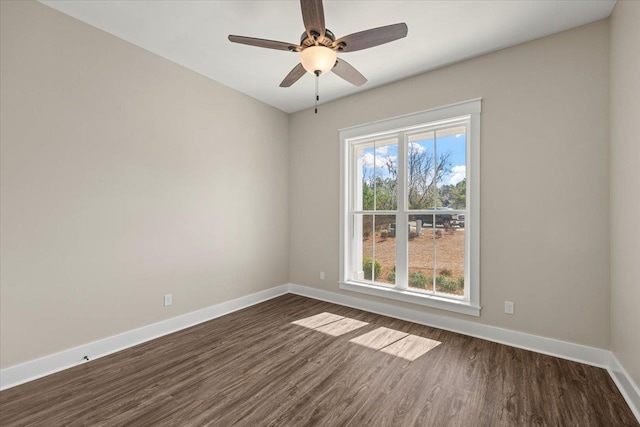 empty room featuring ceiling fan and dark hardwood / wood-style floors