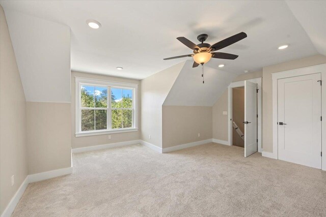 bonus room featuring light colored carpet, vaulted ceiling, and ceiling fan