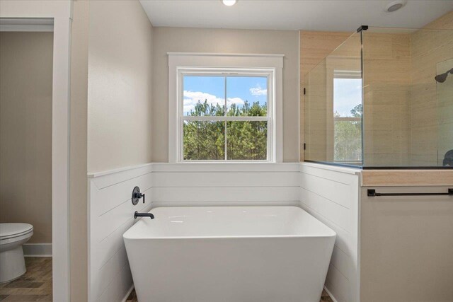 bathroom featuring wood-type flooring, toilet, and independent shower and bath