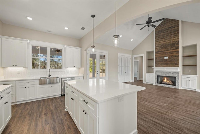 kitchen with white cabinets, dishwasher, sink, and tasteful backsplash