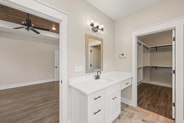 bathroom featuring hardwood / wood-style flooring, ceiling fan, and vanity