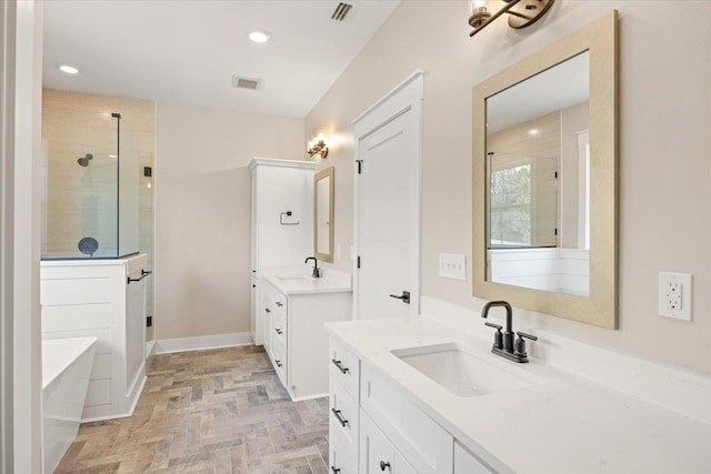 bathroom with shower with separate bathtub and vanity