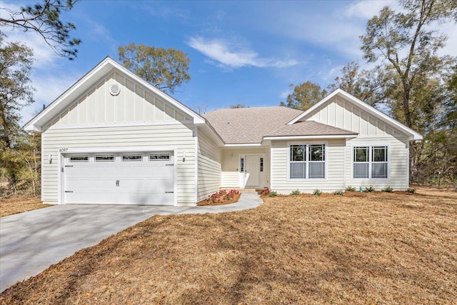 view of front of property featuring a garage and a front lawn