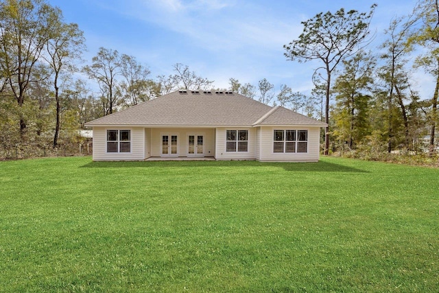 rear view of house with a lawn