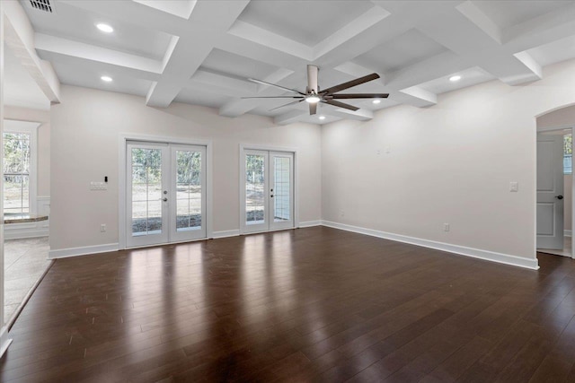 spare room with beamed ceiling, coffered ceiling, dark hardwood / wood-style flooring, and french doors