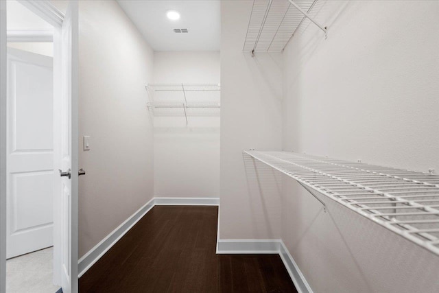 spacious closet featuring hardwood / wood-style floors