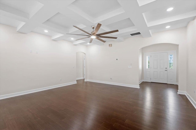 spare room featuring coffered ceiling, ceiling fan, dark hardwood / wood-style flooring, and beamed ceiling