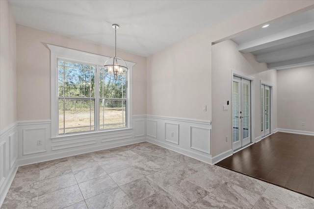 unfurnished dining area with beamed ceiling and a notable chandelier