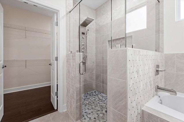 bathroom featuring shower with separate bathtub and hardwood / wood-style floors