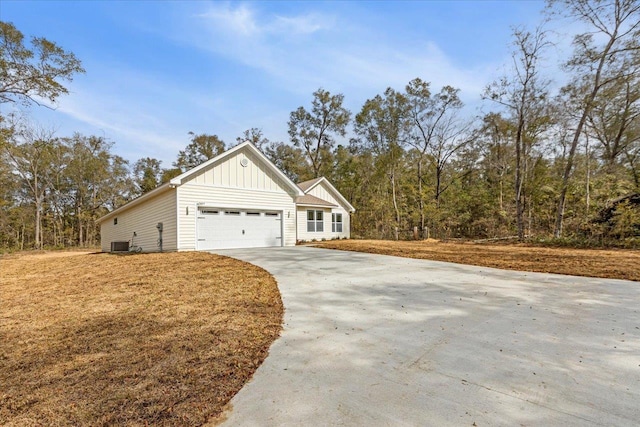 view of front of home with a garage and central air condition unit