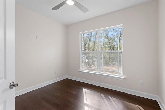 spare room with dark hardwood / wood-style floors and ceiling fan