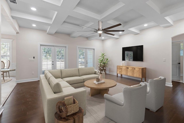 living room featuring french doors, coffered ceiling, dark hardwood / wood-style flooring, ceiling fan, and beam ceiling