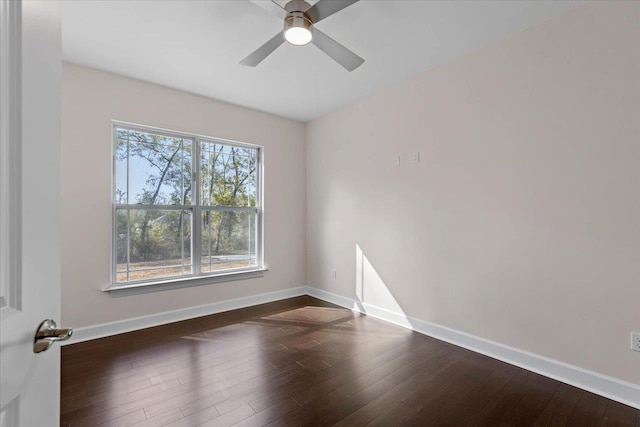 spare room with dark wood-type flooring and ceiling fan