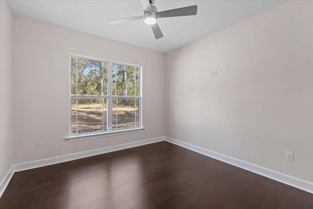 empty room with ceiling fan and dark hardwood / wood-style flooring