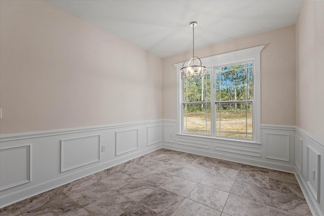 unfurnished room featuring an inviting chandelier