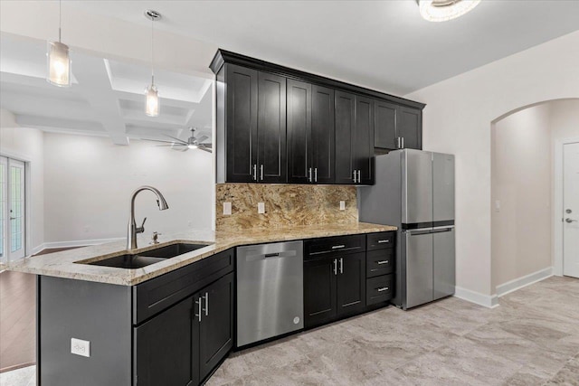 kitchen with sink, hanging light fixtures, stainless steel appliances, tasteful backsplash, and kitchen peninsula