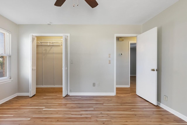 unfurnished bedroom featuring light wood-type flooring, a closet, and ceiling fan