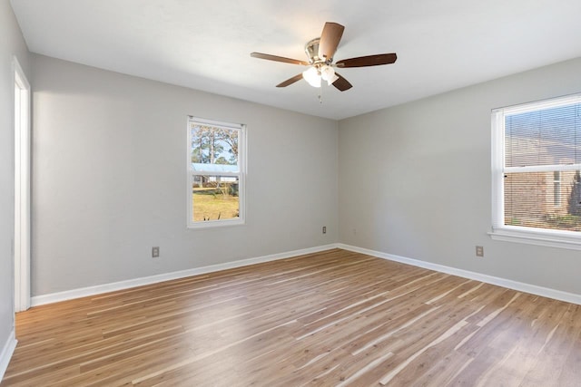 spare room featuring light hardwood / wood-style flooring and ceiling fan