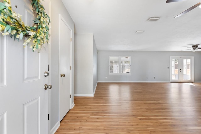 entrance foyer with light wood-type flooring, french doors, and ceiling fan