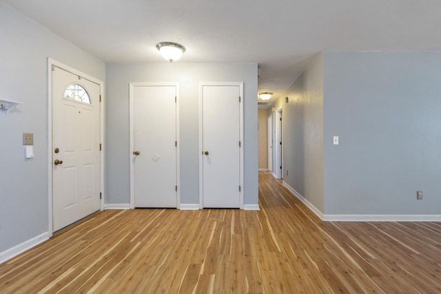 foyer entrance with light hardwood / wood-style flooring