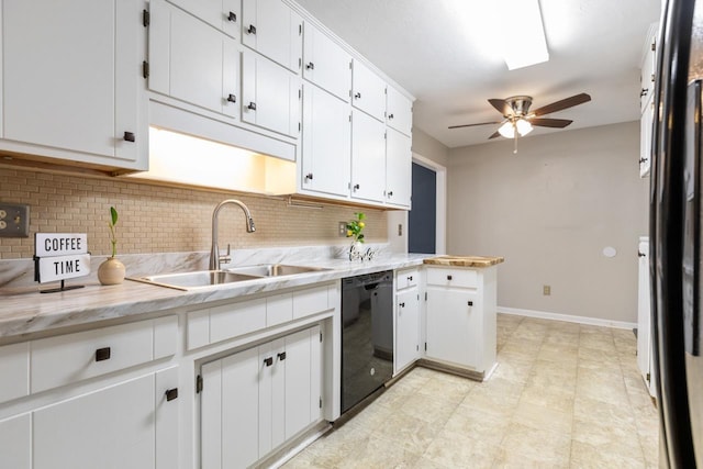 kitchen with white cabinets, sink, black dishwasher, and decorative backsplash