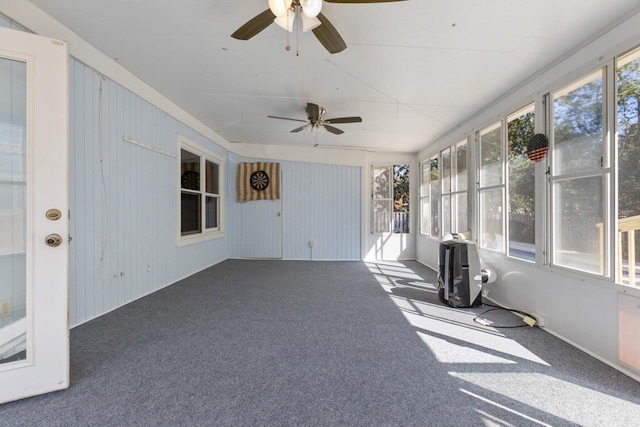 unfurnished sunroom with ceiling fan